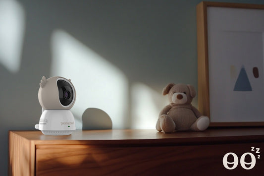 peekyboo non-wifi 2k baby camera on top of a dresser with a teddy bear in the background and sharp directional lighting