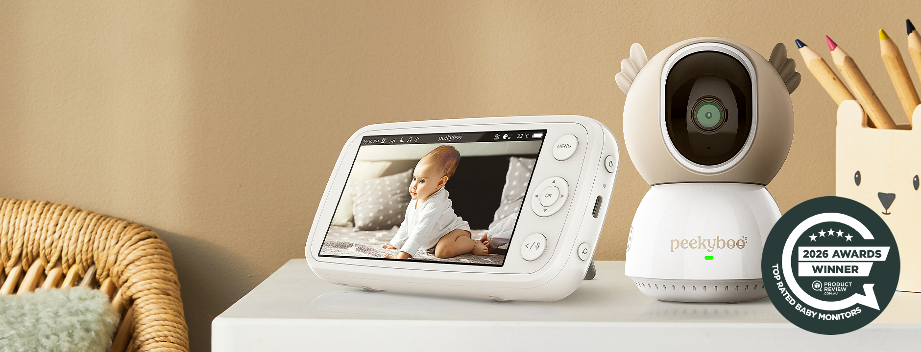 Baby monitor with screen displaying a baby and camera on a table with an 'Awards Winner' badge.