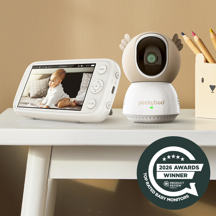 Baby monitor with screen displaying a baby and camera on a table with an 'Awards Winner' badge.
